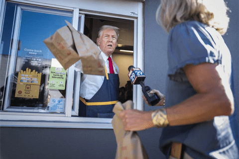Donald Trump handing out a paper bag at a drive through window