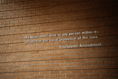 a brick wall with part of the fourteenth amendment on it.