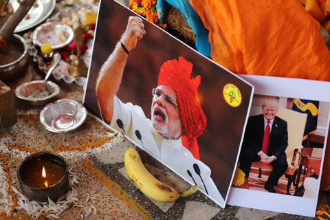 An image of Modi in front of prayer items