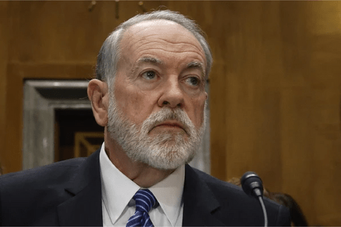 a man in a suit with a white beard