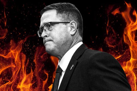 A black and white image of a man with a flames behind him