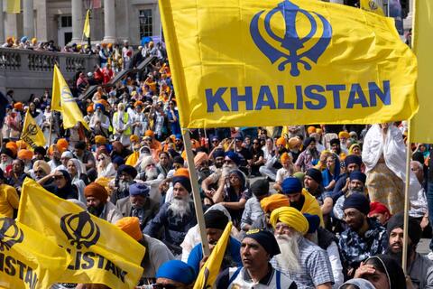 a crowd carrying flags reading Khalistan