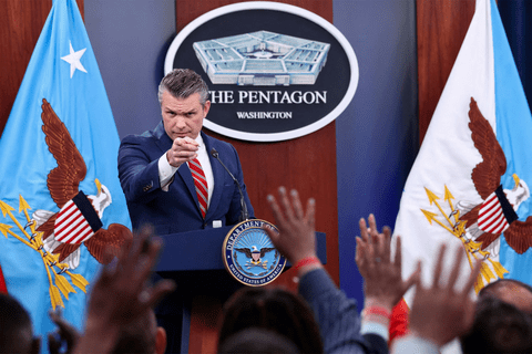 Pete hegseth pointing at an audience of raised hands