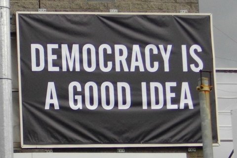 A banner that reads "Democracy is a good idea"