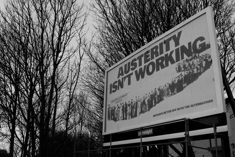 a banner that reads "Austerity isn't working"