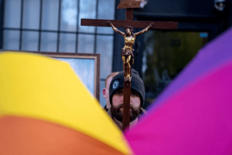 a man carrying a crucifix
