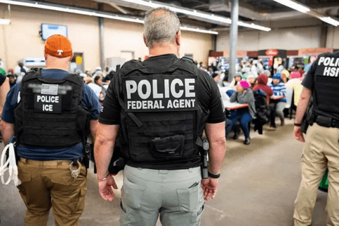 Two men with their back to the camera. One says "police"