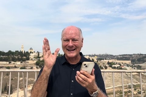 Pastor Rick Ridings holds cell phone in front of Jerusalem