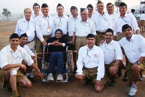 A group picture of men in white shirts and brown shorts