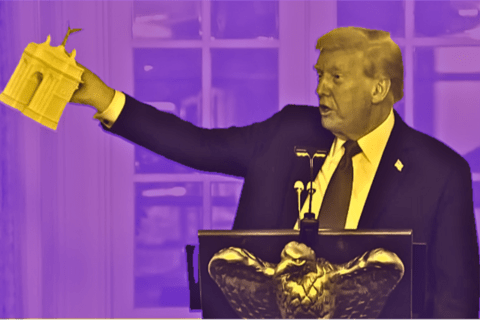 Trump holds a model of the Arc De Trump