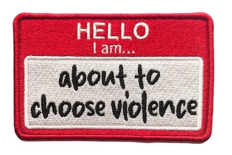 Name tag reads: "Hello I am about to choose violence"