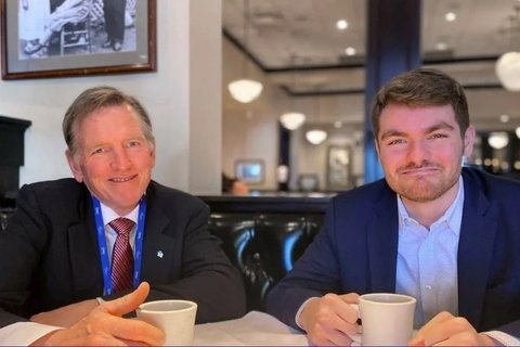 Nick Fuentes and Paul Gosar smile at the camera