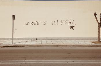 No One is Illegal painted on a wall
