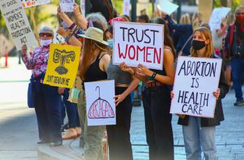 a group of protesters holding pro-abortion signs