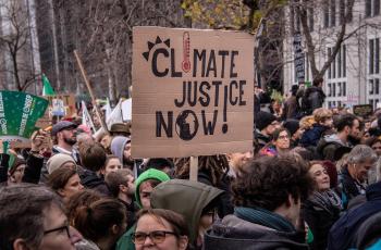 An protest sign that says "climate justice now!"