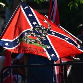 A confederate flag with a "don't tread on me" symbol on it.