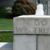  The word In God We Trust engraved in a stone staircase