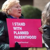 A sign that says "I stand with planned parenthood"