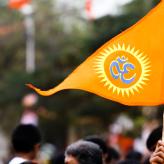 An orange triangle flag with an "Om" on it.