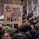 An protest sign that says "climate justice now!"