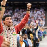 Group of people cheering with their arms in the air