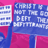 Two protestors with signs
