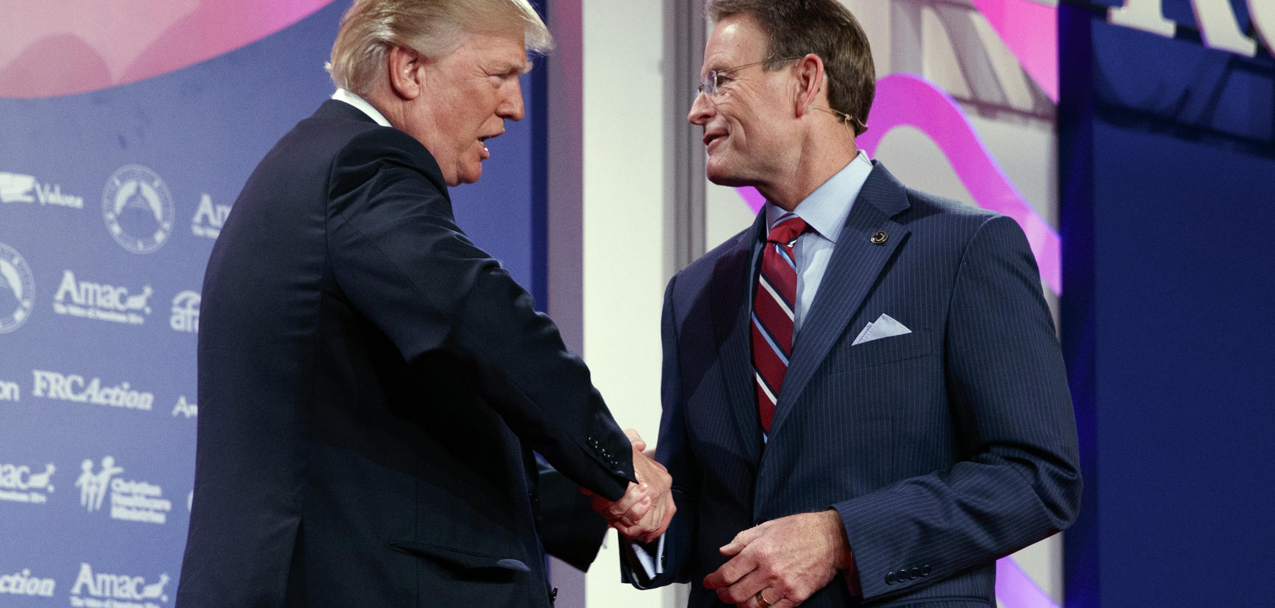  Donald Trump shakes hands with Family Research Council president Tony Perkins at the 2017 Value Voters Summit, Friday, Oct. 13, 2017, in Washington. 