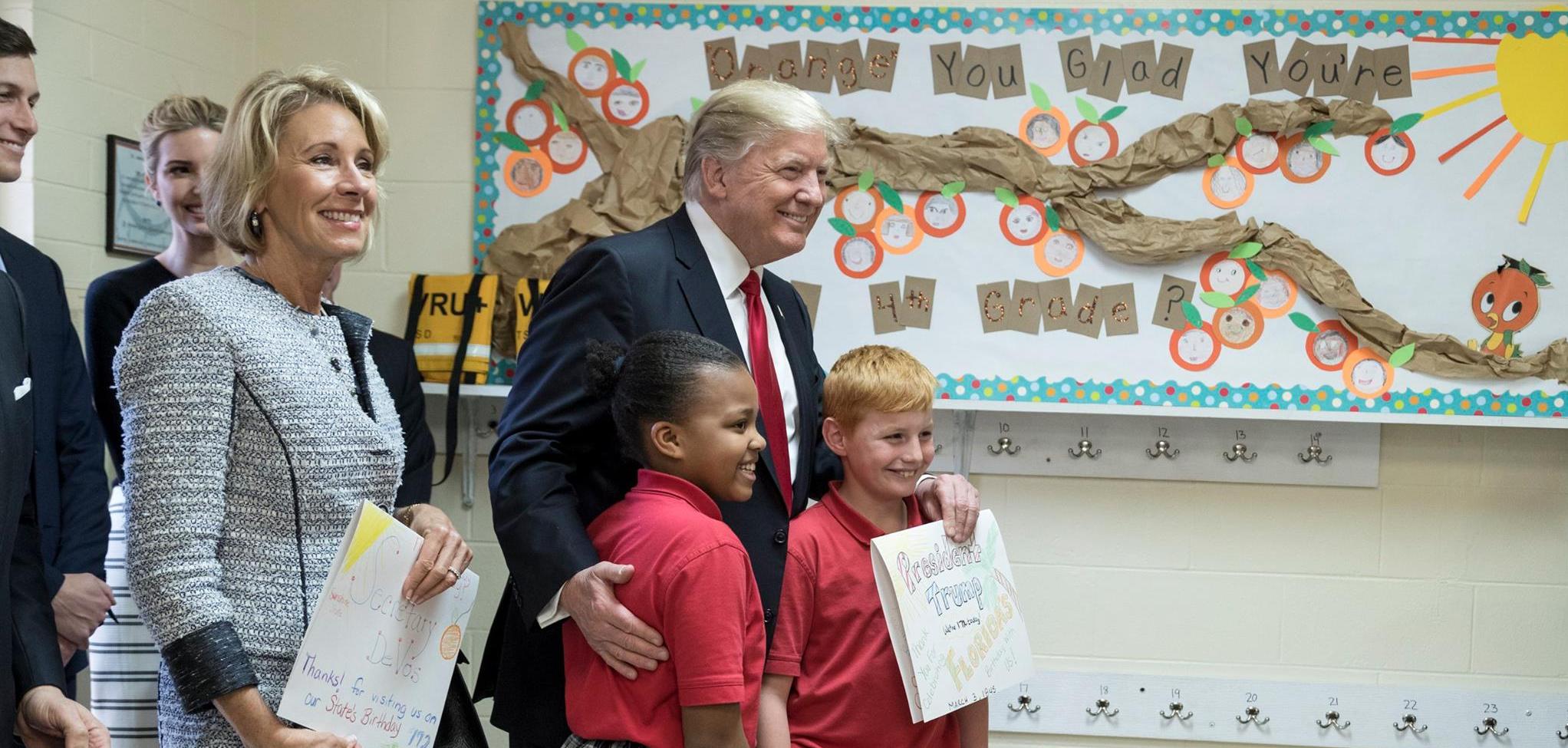 President Donald Trump and U.S. Secretary of Education Betsy DeVos poses for a photo with students of Saint Andrew Catholic School on March 3, 2017.