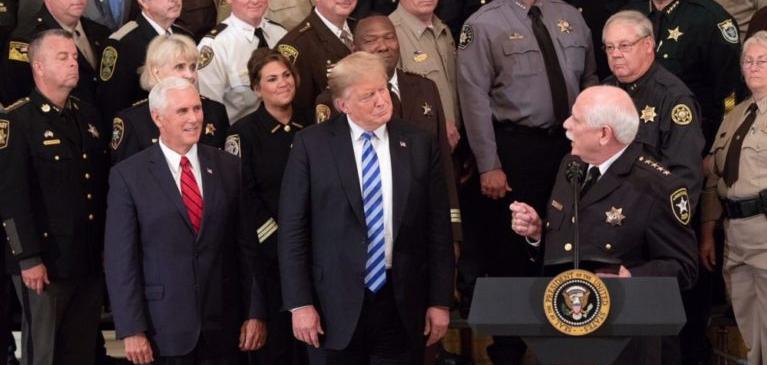 U.S President Donald Trump and Vice President Mike Pence look on as Sheriff Thomas Hodgson of Bristol County Massachusetts delivers remarks in the East Room of the White House September 5, 2018 in Washington, DC.