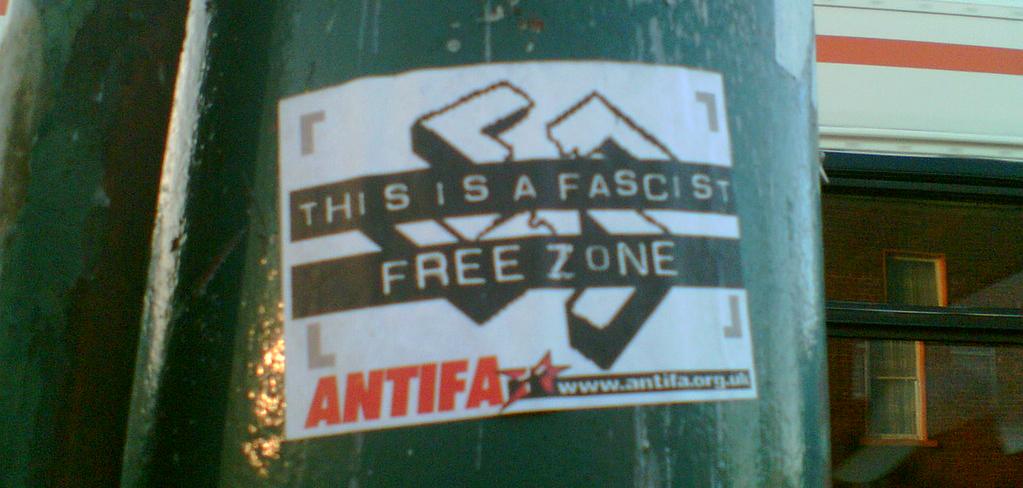 A flyer on a pillar that reads: "This is a fascist free zone. Antifa"