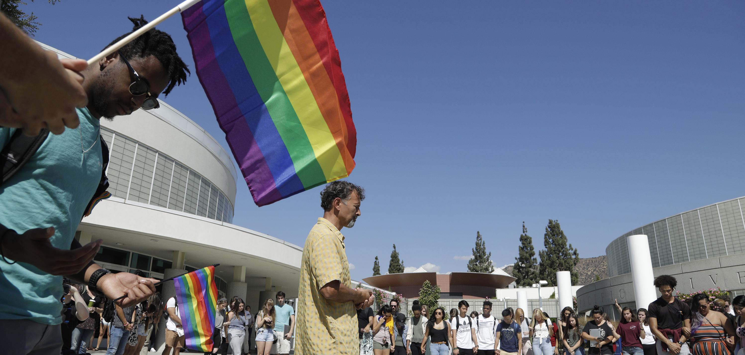 A professor offers a prayer during a rally by the LGBTQ Christian community at Azusa Pacific University to show support after the school reinstated a ban on same-sex relationships, October 1, 2018. Credit: Myung J. Chun/Los Angeles Times via Getty Images.