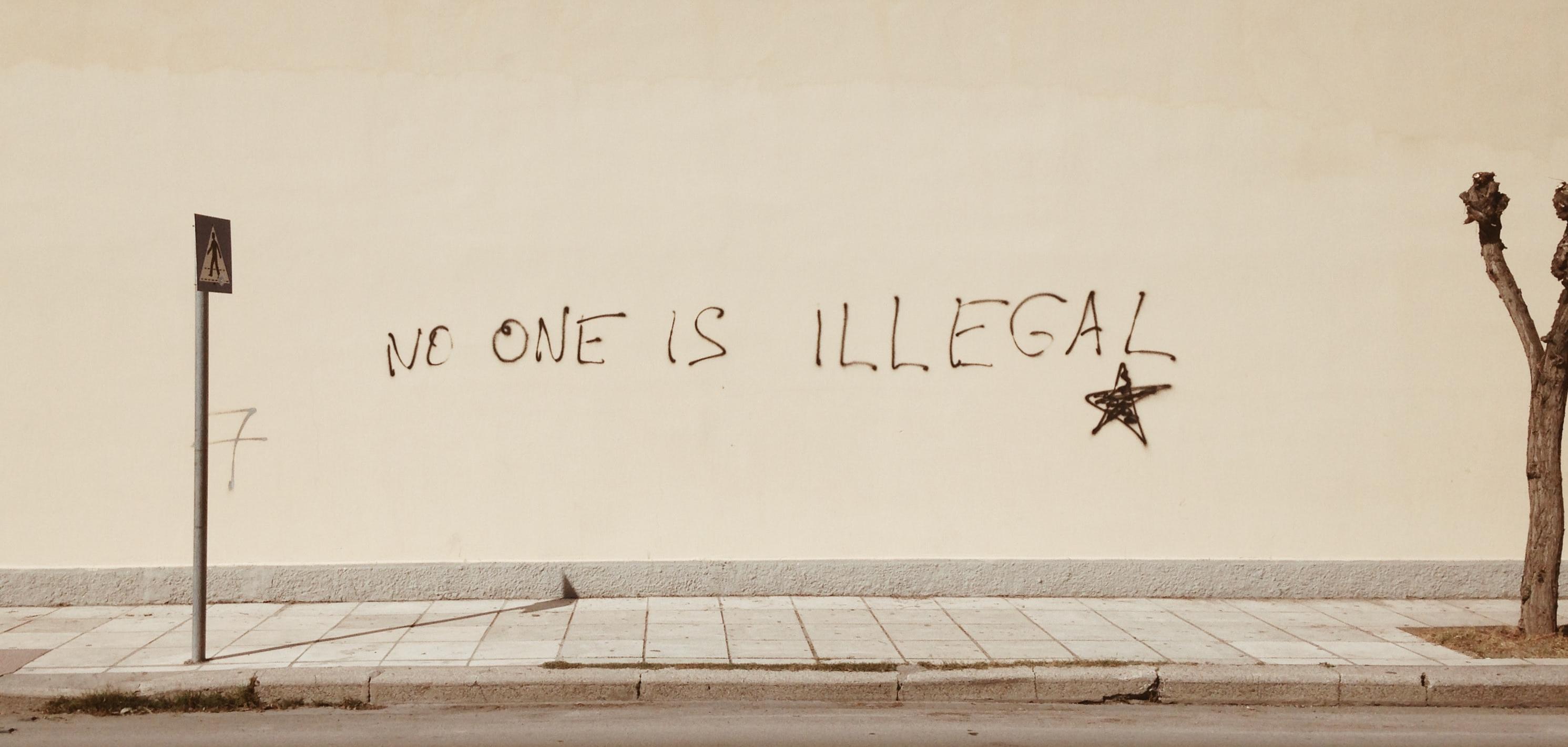 No One is Illegal painted on a wall