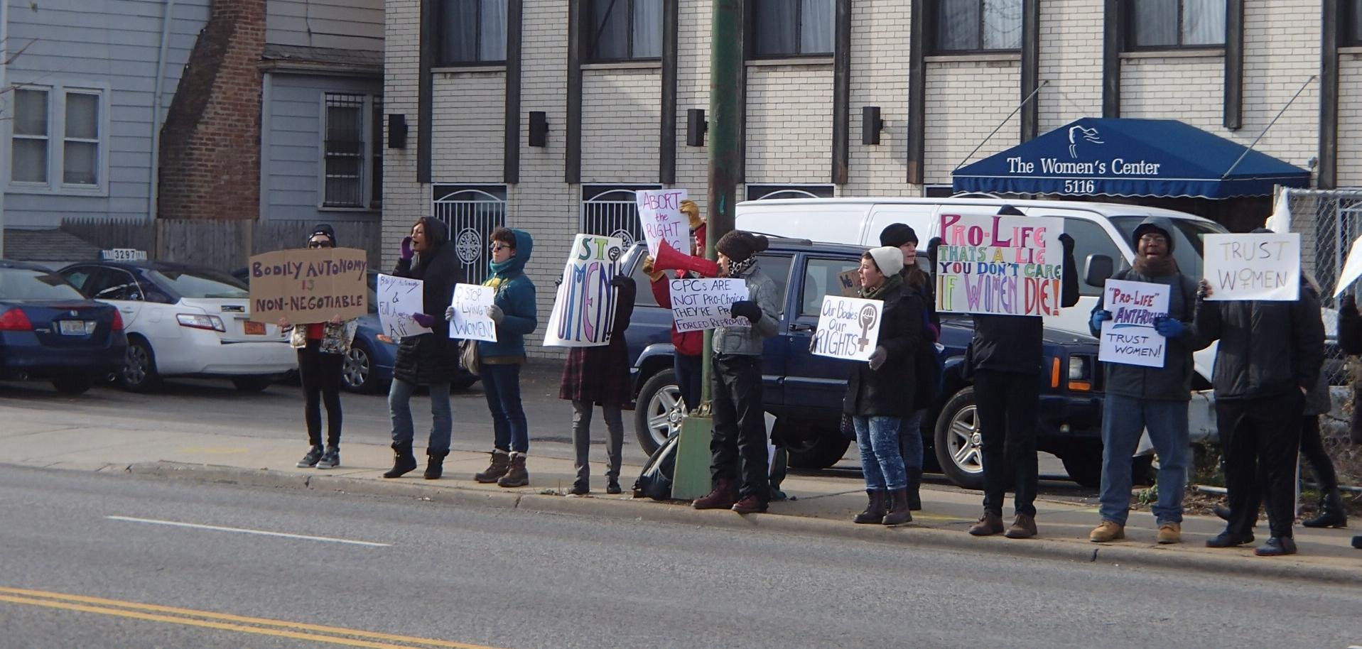 A group of people in Chicago holding protest signs