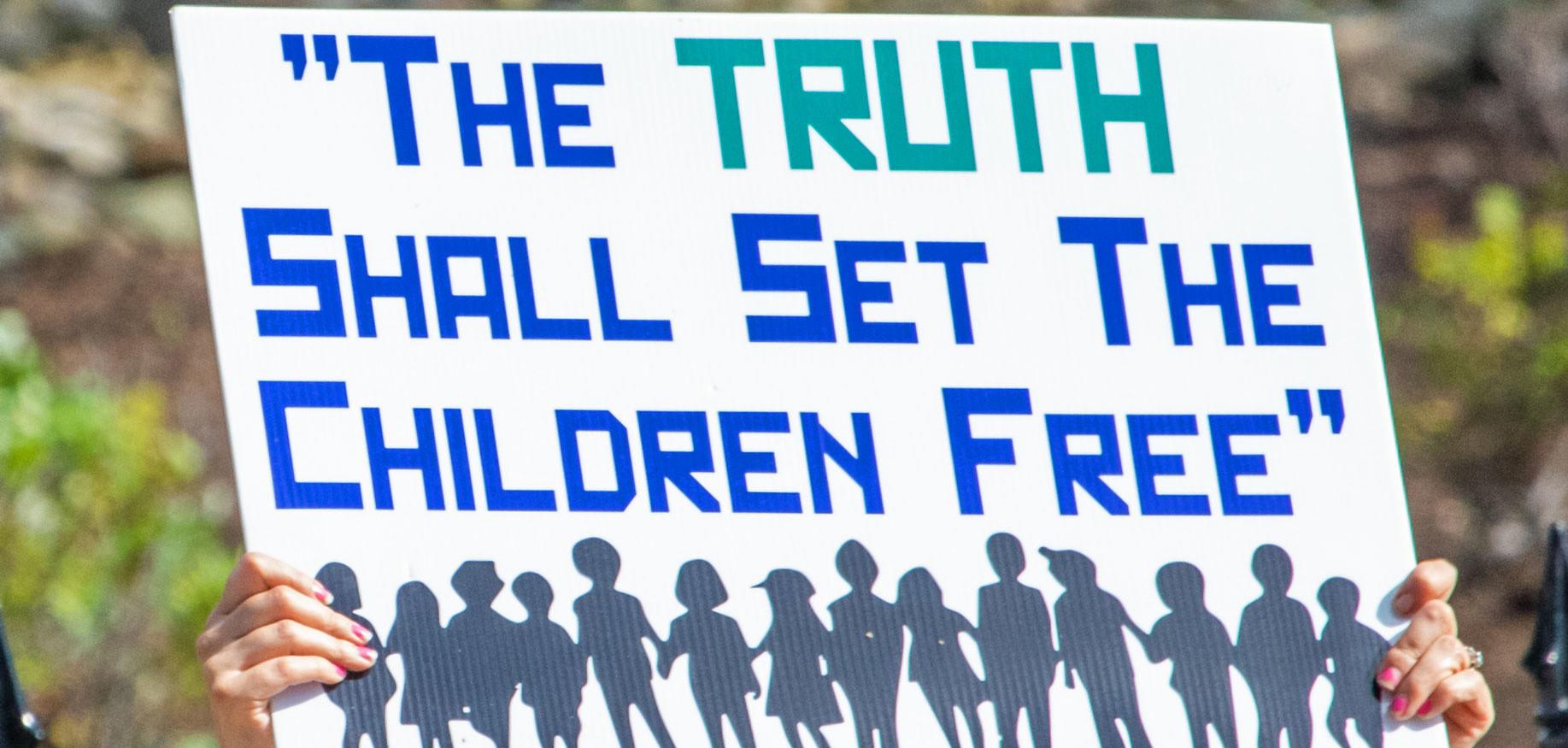 A sign that says "The Truth shall set the children free."