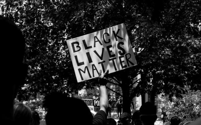 A protester holding a sign that says Black Lives Matter