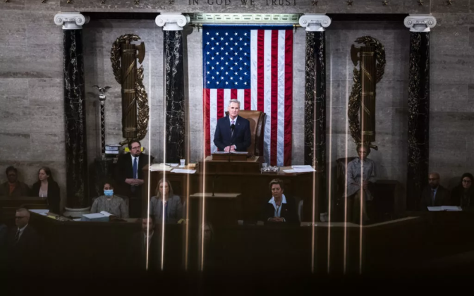 Kevin McCarthy standing in front of an American flag. 