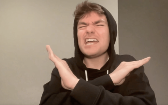 A picture of Nick Fuentes in a black hoodie.