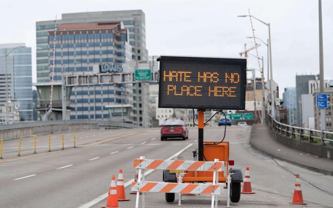 A road sign that says "Hate has no place here"