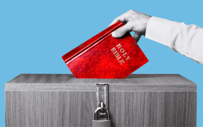 A hand putting a bible in a ballot box