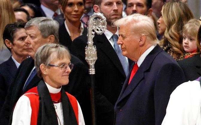 A woman in bishop's clothing talking to a man in a suit.