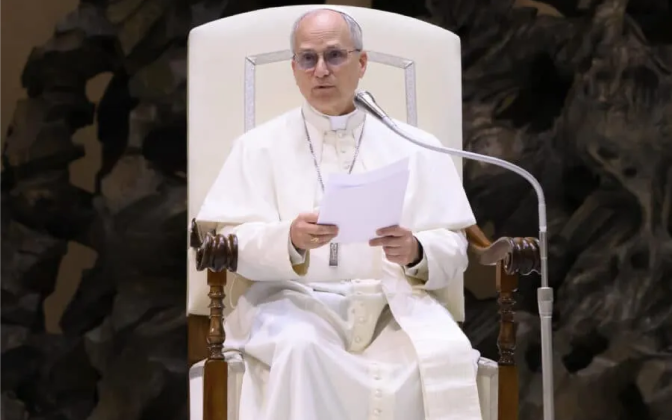 a man in white robes sitting in a white chair
