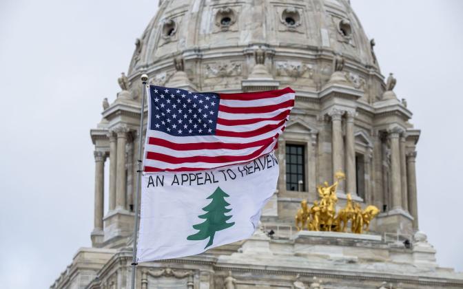An American flag and an Appeal to Heaven flag flying together.