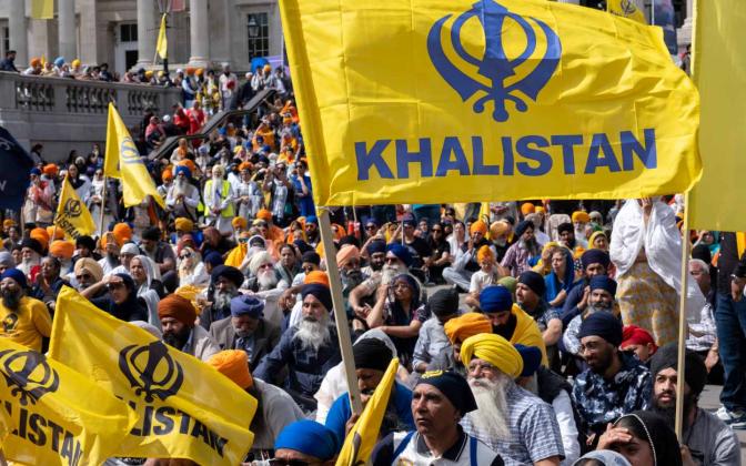 a crowd carrying flags reading Khalistan